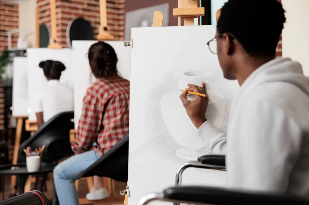 Disabled man in wheelchair in an art class