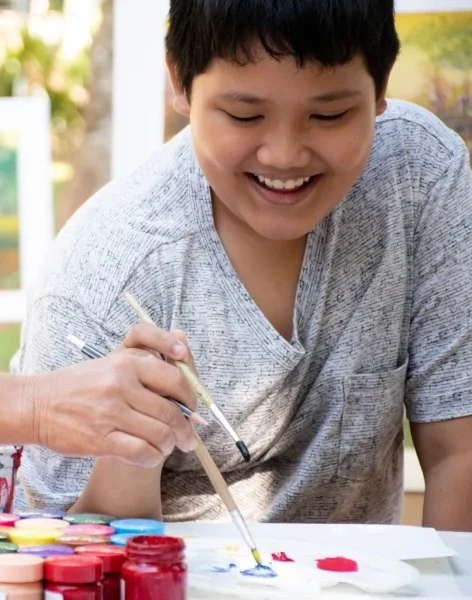 Disabled boy enjoying painting