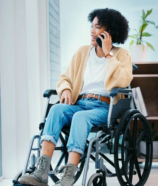 Disabled woman in wheelchair talking on mobile phone